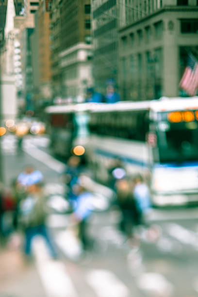istock Abstract defocused street scene with pedestrians and buses 538470340