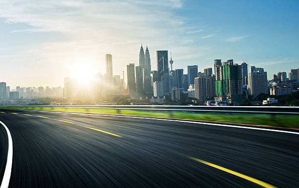 istock freeway at sunrise,motion blur with city background . 538471012