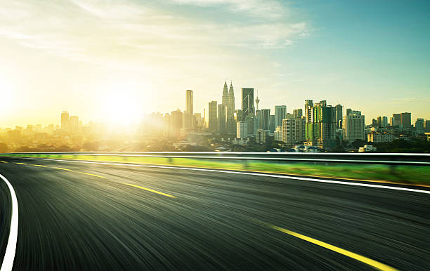 istock freeway at sunset, motion blur with city background . 538471048