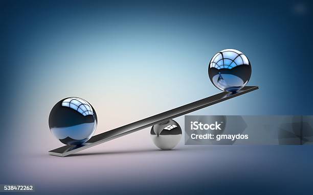 Metallic Blue Orbs Balancing On Small Silver Ball Metal Beam Stock Photo - Download Image Now