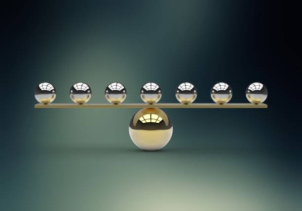 istock Seven gold shiny balls balanced on a large gold sphere 538472622