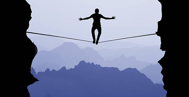 istock Man balancing on the rope challenge and risk taking concept 538472804