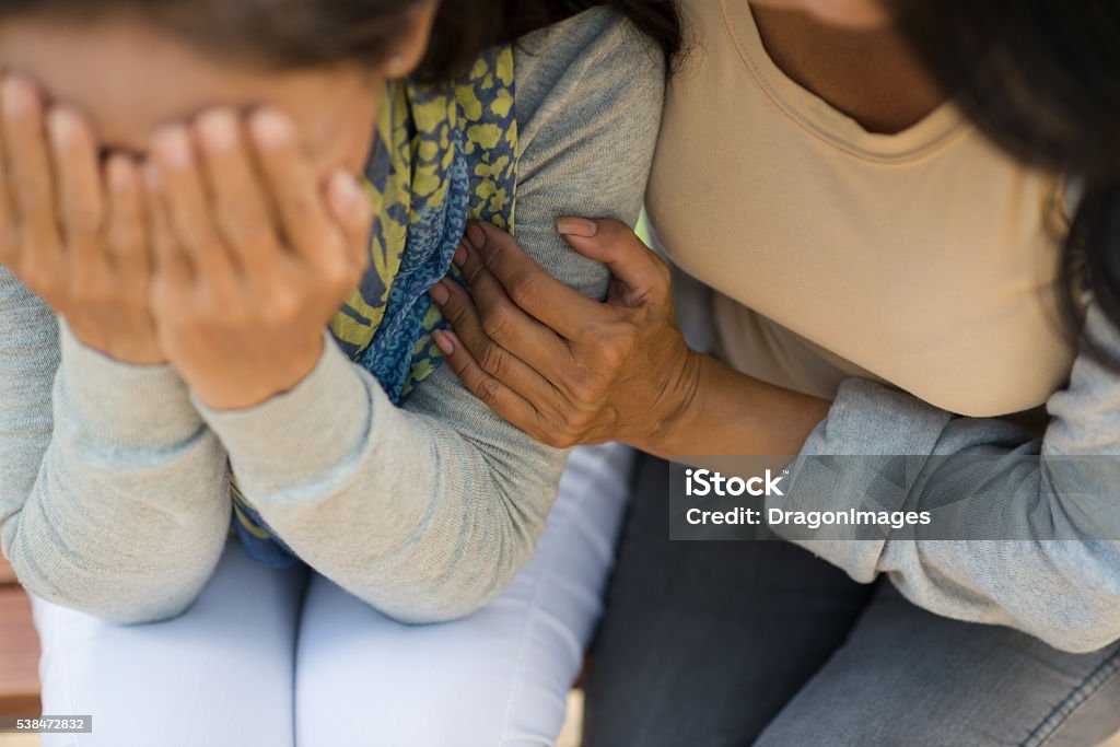 Comforting Woman comforting desperate hopeless friend, view from above Consoling Stock Photo