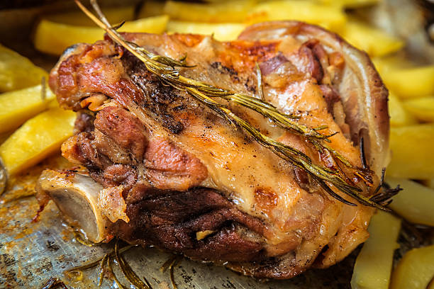 Lamb Meat with rosemary in a tray.
