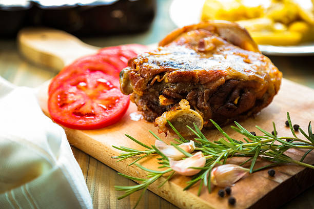 Lamb Meat with Tomatoes on cutting board.