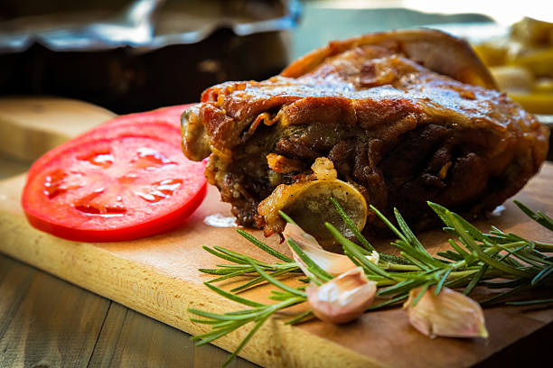 Lamb Meat with Tomatoes on cutting board.