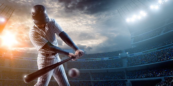 Baseball player about to strike ball during baseball game on outdoor stadium under dramatic stormy skies.