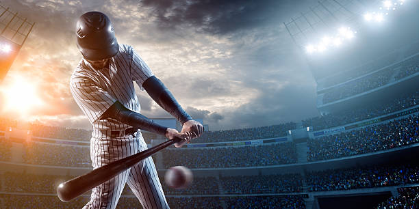 Baseball player Baseball player about to strike ball during baseball game on outdoor stadium under dramatic stormy skies. baseball ball photos stock pictures, royalty-free photos & images