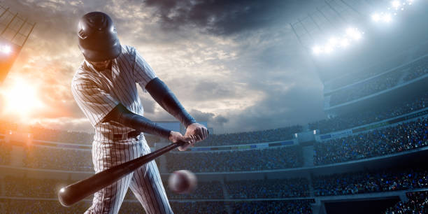 Baseball player Baseball player about to strike ball during baseball game on outdoor stadium under dramatic stormy skies. baseball ball stock pictures, royalty-free photos & images