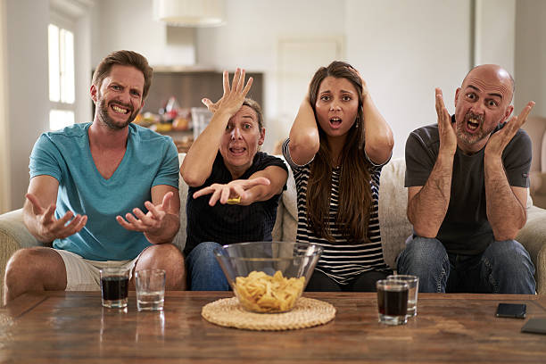 istock disappointed fans in front of tv 538476176