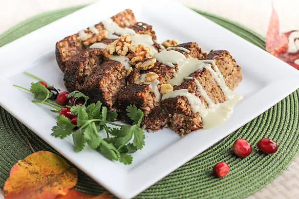 Beautiful vegetarian meat-loaf served with gravy and garnished with parsley