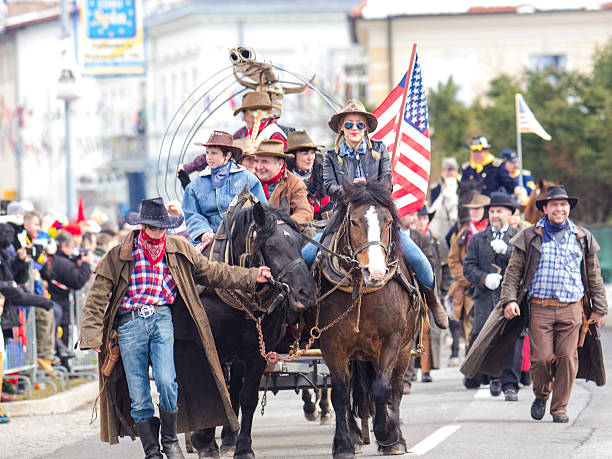 The Wild West on Carnival Cerknica, Slovenia - February 15, 2015: People dressed like Wild West pilgrims protected with army and USA flag on Carnival in Cerknica. The background is blurred. cerknica lake stock pictures, royalty-free photos & images