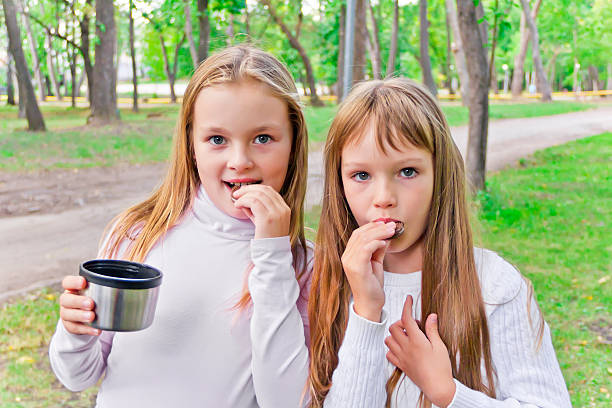 istock Cute two eating girls 538477173