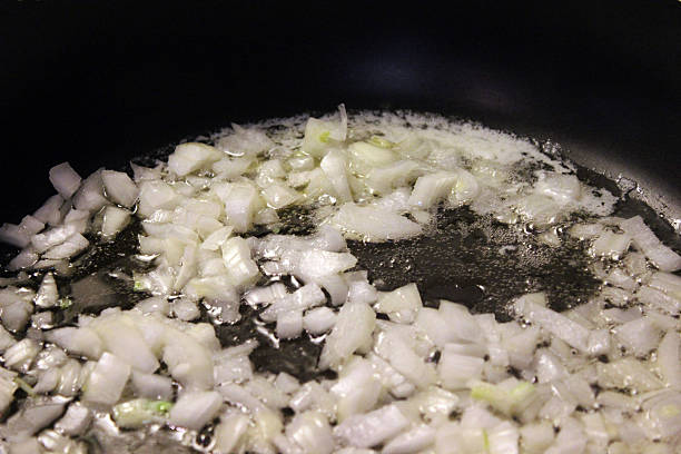 istock Diced Onions Sizzle while Cooking in Saucepan 538478195