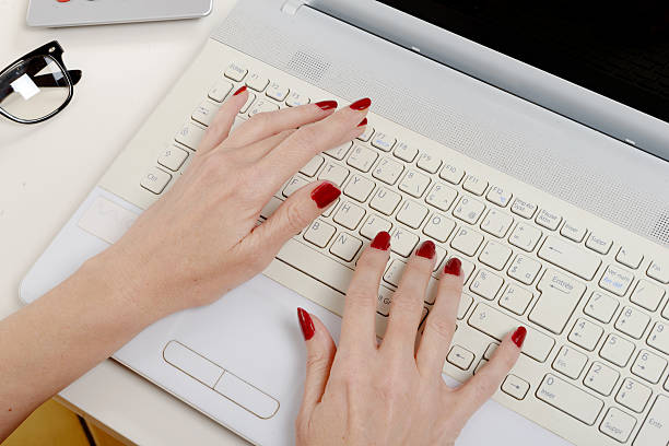 a woman office worker typing on the keyboard
