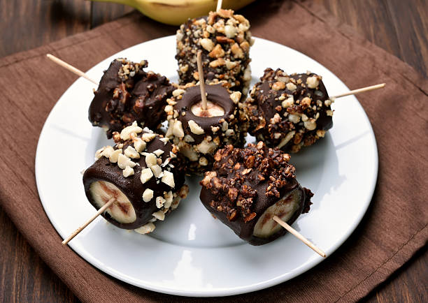 istock Frozen banana covered with chocolate and peanuts 538479696