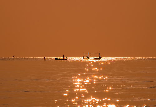 silhouette fisherman boat occupation out fishing amid sea beautiful nature warm light shine