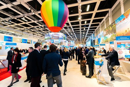 Berlin, Germany - March 10, 2016: Various exhibitor booths seen during the ITB Berlin 2016, one of Germany's biggest travel fairs held in Messe Berlin in Berlin, Germany. Visitors can be seen walking around the aisles.