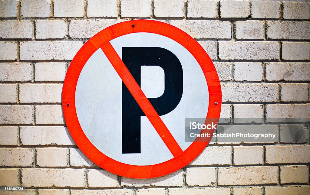 No Parking Sign No Parking Sign posted on Wall Brick Wall Stock Photo