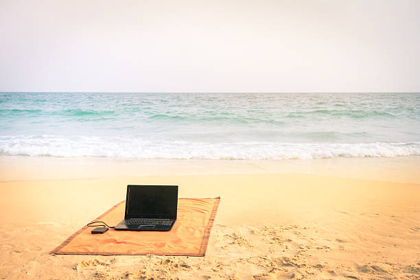 istock Computer laptop at the beach on tropical destination 538480755