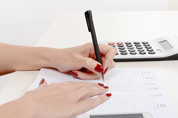 istock Closeup of woman's hand writing on paper 538480902