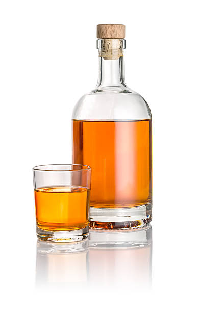 istock Bottle and drinking glass filled with amber liquid 538482355