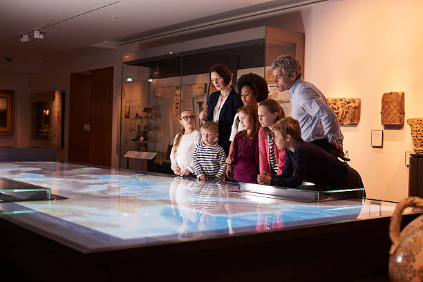 istock Pupils On School Field Trip To Museum Looking At Map 538483276
