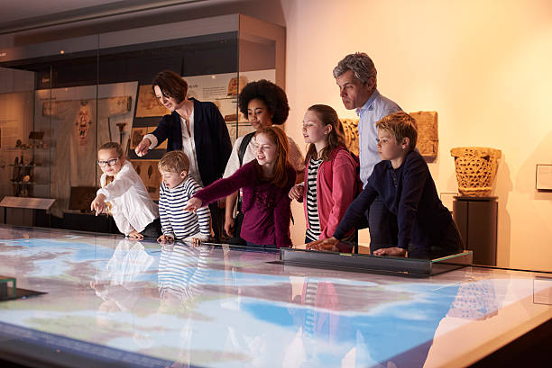 istock Pupils On School Field Trip To Museum Looking At Map 538483278