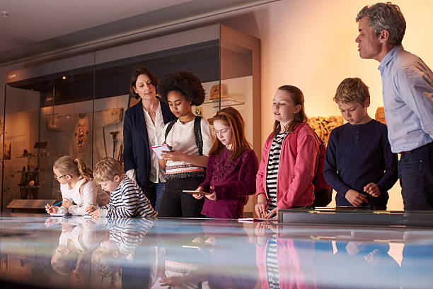 istock Pupils On Trip To Museum Looking At Map And Making 538483284