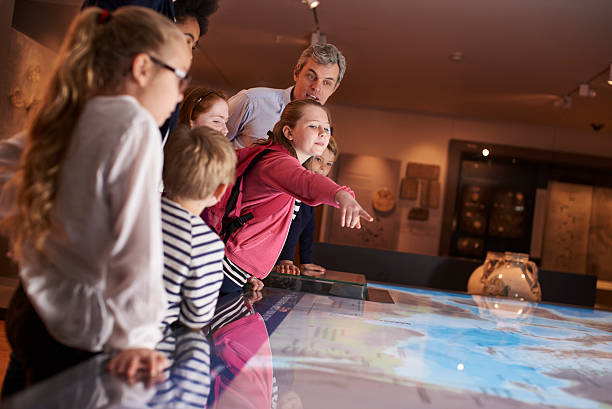 istock Pupils On School Field Trip To Museum Looking At Map 538483326