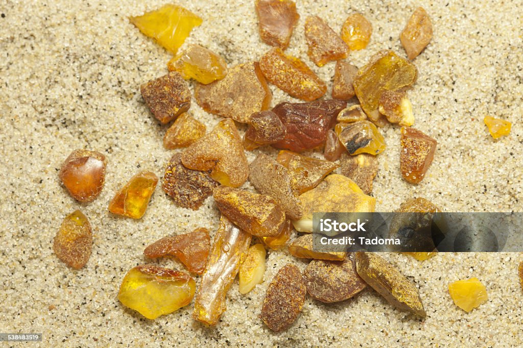 Raw amber Raw amber from the shores of the Baltic Sea in the Kaliningrad region , lying on the sand 2015 Stock Photo