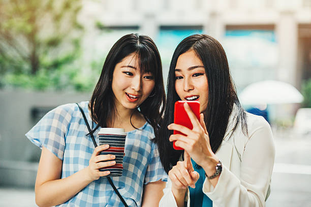 istock Japanese girlfriends looking at a smart phone 538484716