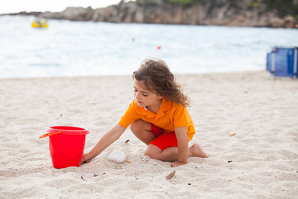 istock girl playing with sand 538485374