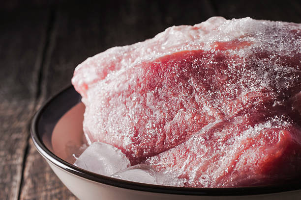 Frozen pork on the plate stock photo