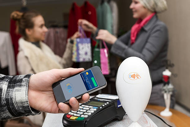 istock Man completing mobile Payment at Store Cashiers Desk with Terminal 538486004