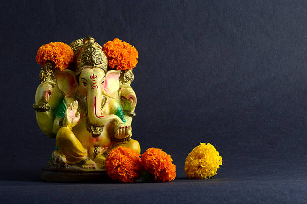 Hindu God Ganesha. Ganesha Idol on grey Background. stock photo