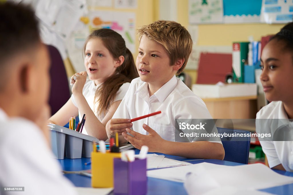 Primary school children work together in class, close up School Children Stock Photo