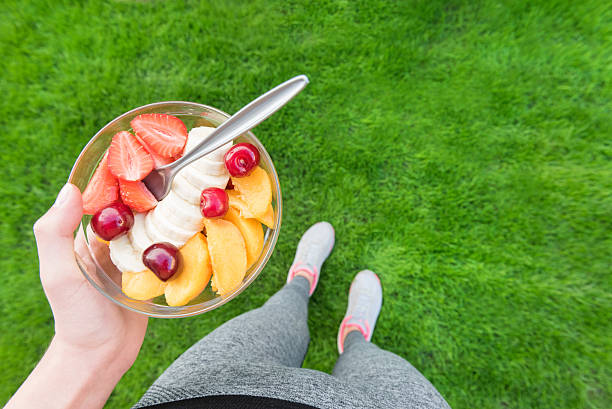 istock Young girl eating a fruit salad after a workout . 538487796