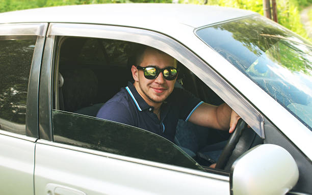 istock Man in sunglasses in the car - outside view 538489078