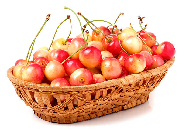 istock yellow cherries in a wicker basket isolated on white background 538489366