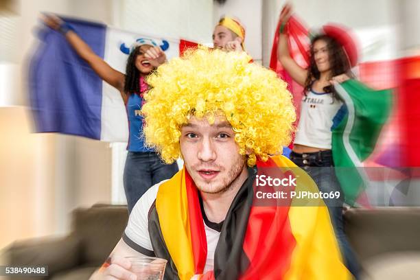 German Supporter Holding Glass Of Beer Stock Photo - Download Image Now - 2016, Alcohol - Drink, Arms Outstretched