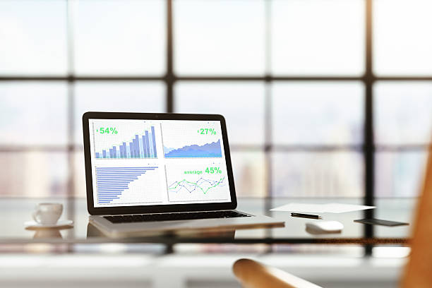 istock Laptop with financial statistics on a glass table with cup 538491030