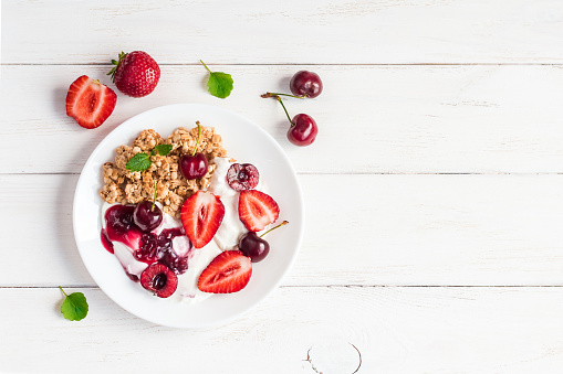 healthy breakfast with yogurt, muesli and berries, top view, flat lay
