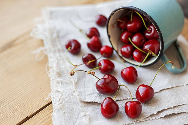 istock Fresh juicy sweet cherries  in old rusty mug. Rustic background 538492478