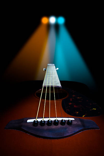 istock acoustic guitar on colorful concert light background 538493062