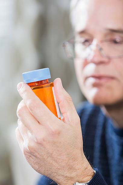istock Mature man holding prescription medicine 538502745