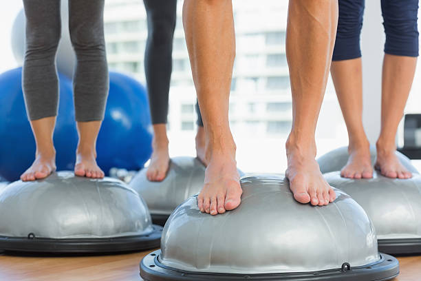 istock Low section of fit people standing on exercise equipment 538507545