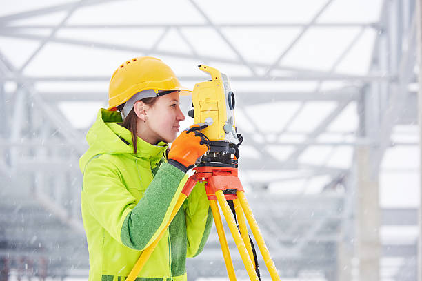 surveyor works with theodolite female surveyor worker working with theodolite transit equipment at road construction site outdoors tacheometer stock pictures, royalty-free photos & images