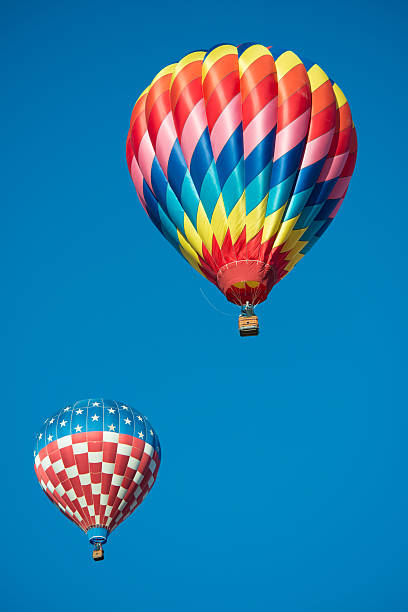 istock Two brightly colored hot air balloons with blue background 538511273