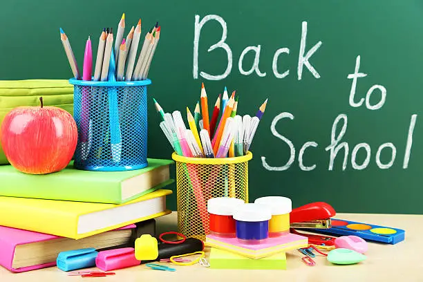 Back to school supplies. Books and blackboard.